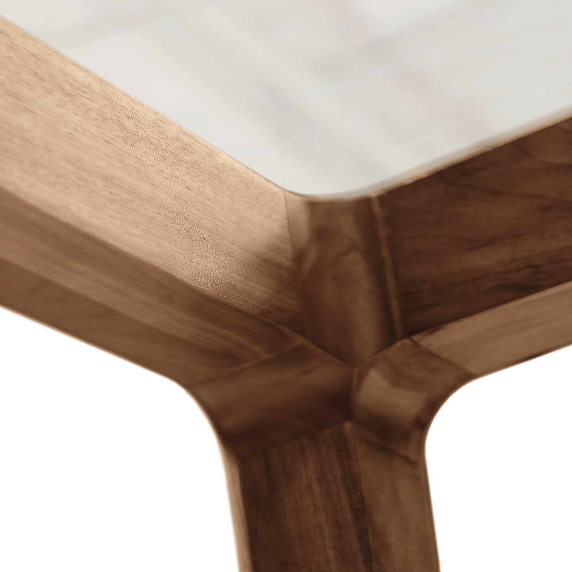 Close-up of a walnut table corner showing the grain detail, minimalist design by Copeland Furniture, and joinery of the Lisse Glass Top Dining Table.