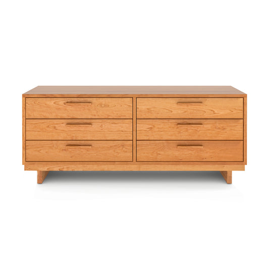 The Loft Double Dresser by Vermont Furniture Designs is crafted from natural solid hardwood and features six drawers arranged in two columns of three. It boasts a light natural wood finish and rectangular handles on each drawer. Standing on four short legs, this piece exemplifies Vermont craftsmanship.