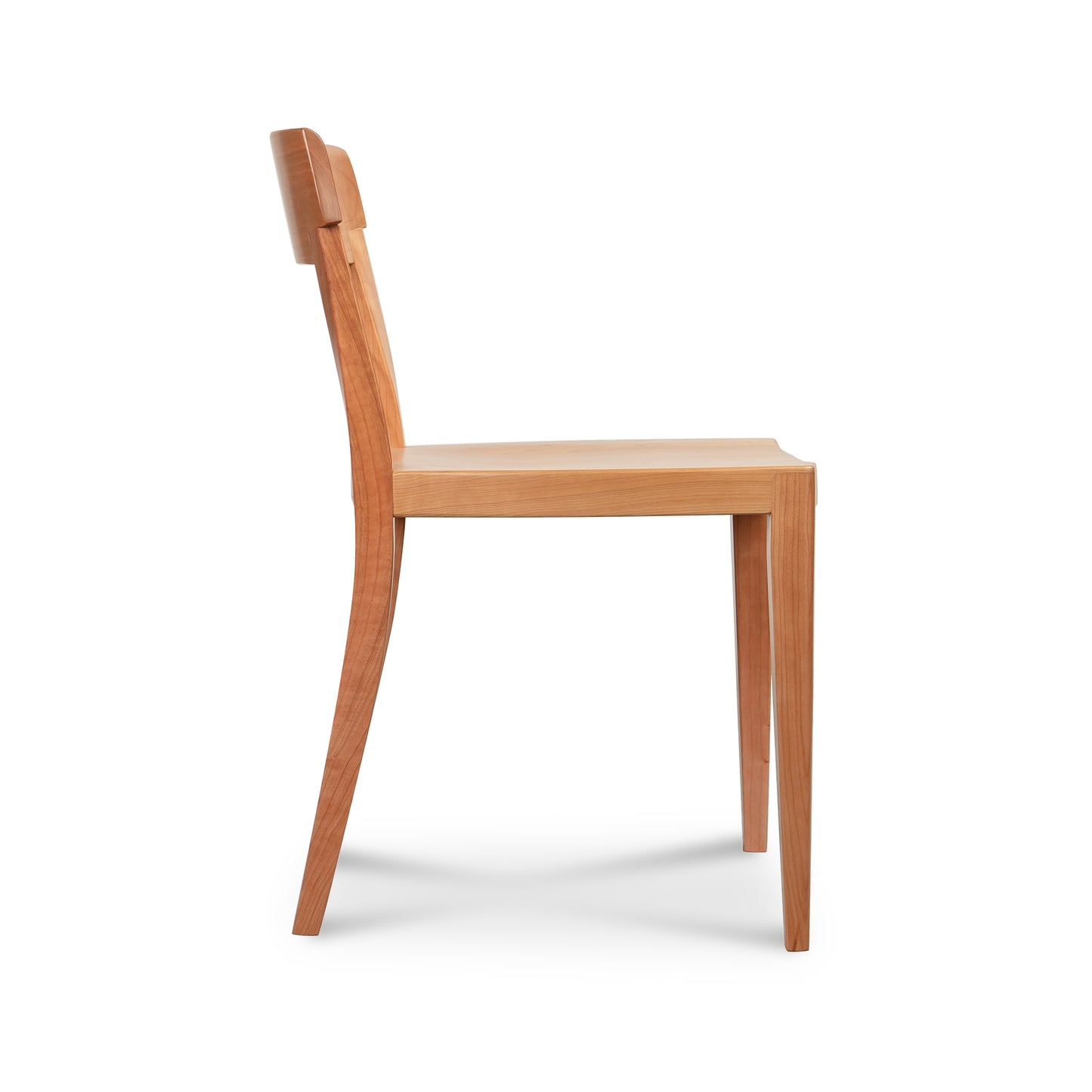 Vermont Woods Studios Ludlow Chair in natural wood, featuring a curved backrest and straight legs, shown from the side to highlight craftsmanship.