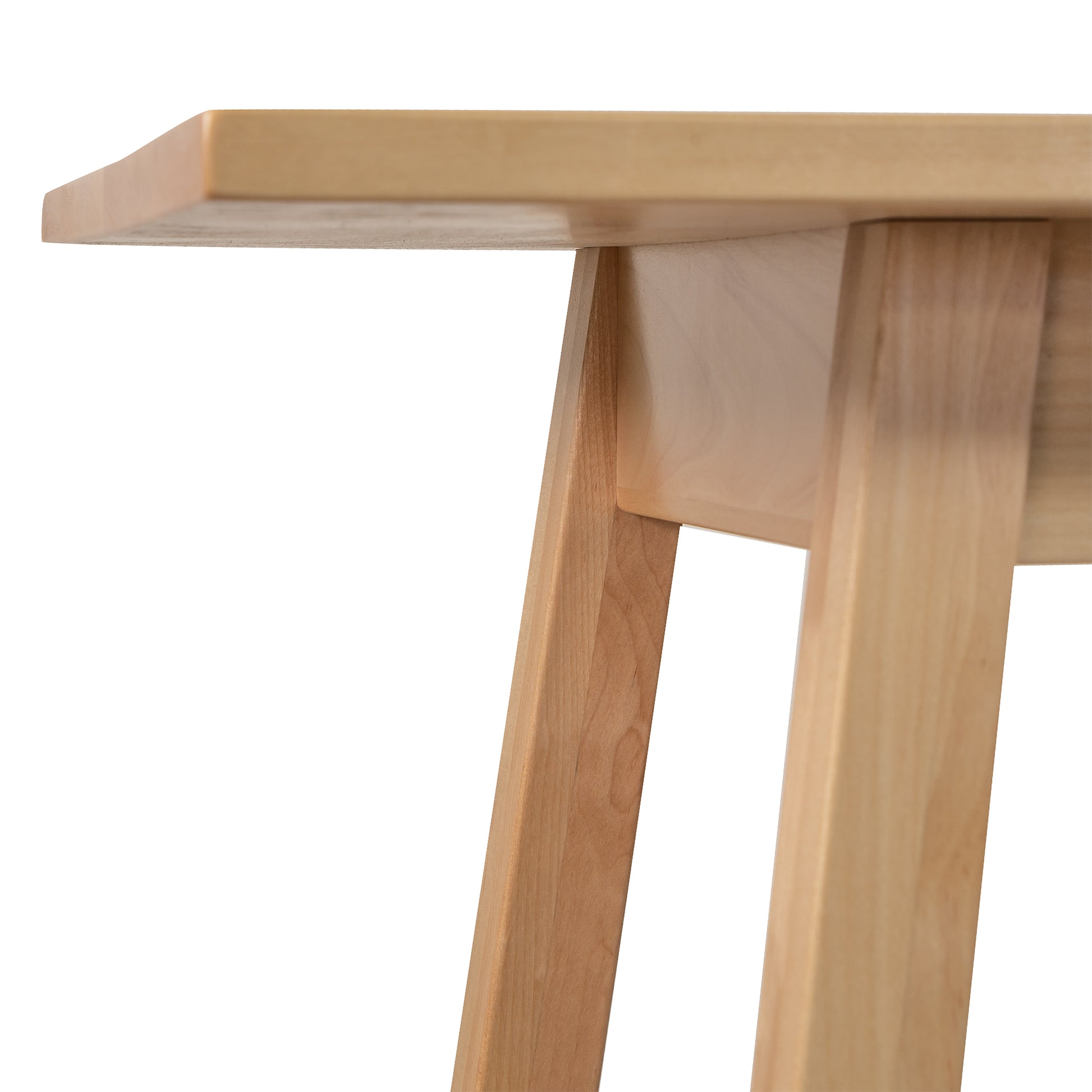A close up of a wooden table with legs.