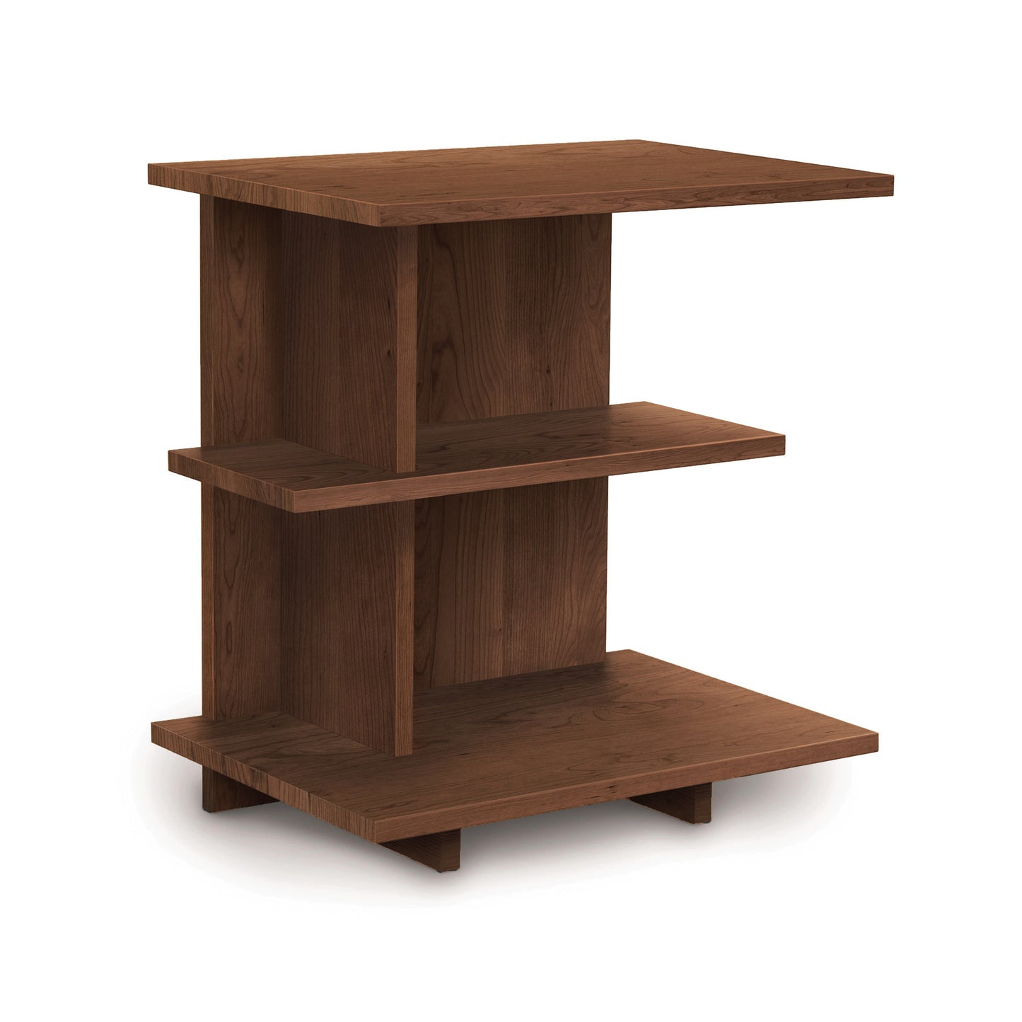 The Mansfield Open Shelf Nightstand by Copeland Furniture is displayed against a white background, showcasing three staggered shelves with a smooth, dark brown finish. The middle shelf is offset to the right, creating a modern and asymmetrical design. This piece adds elegance reminiscent of Copeland Furniture's cherry bedroom furniture collection.