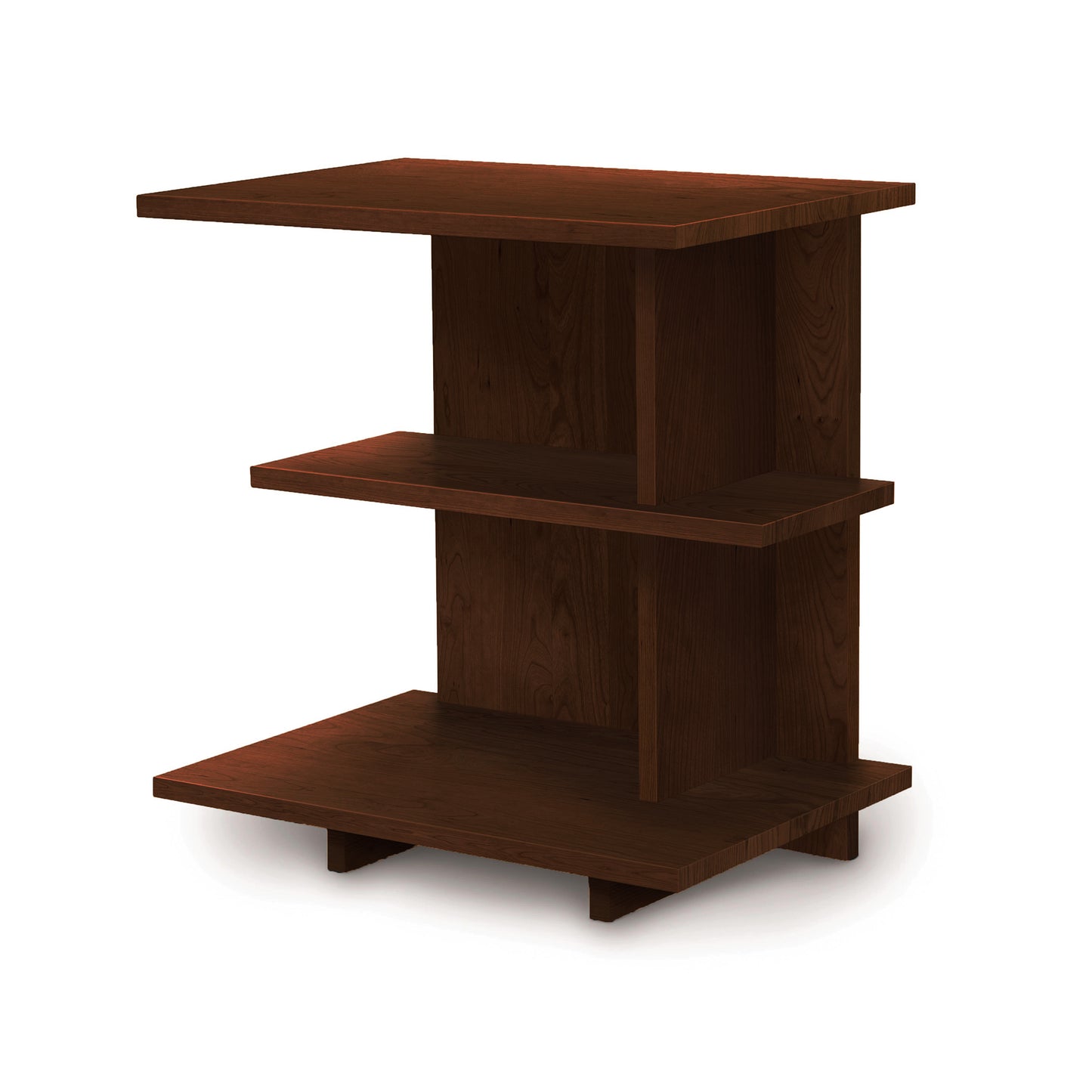 The Mansfield Open Shelf Nightstand by Copeland Furniture is a compact, dark wooden shelf with three rectangular tiers. The shelves are supported by a vertical back panel and sturdy side supports. This minimalist and functional design perfectly complements cherry bedroom furniture.