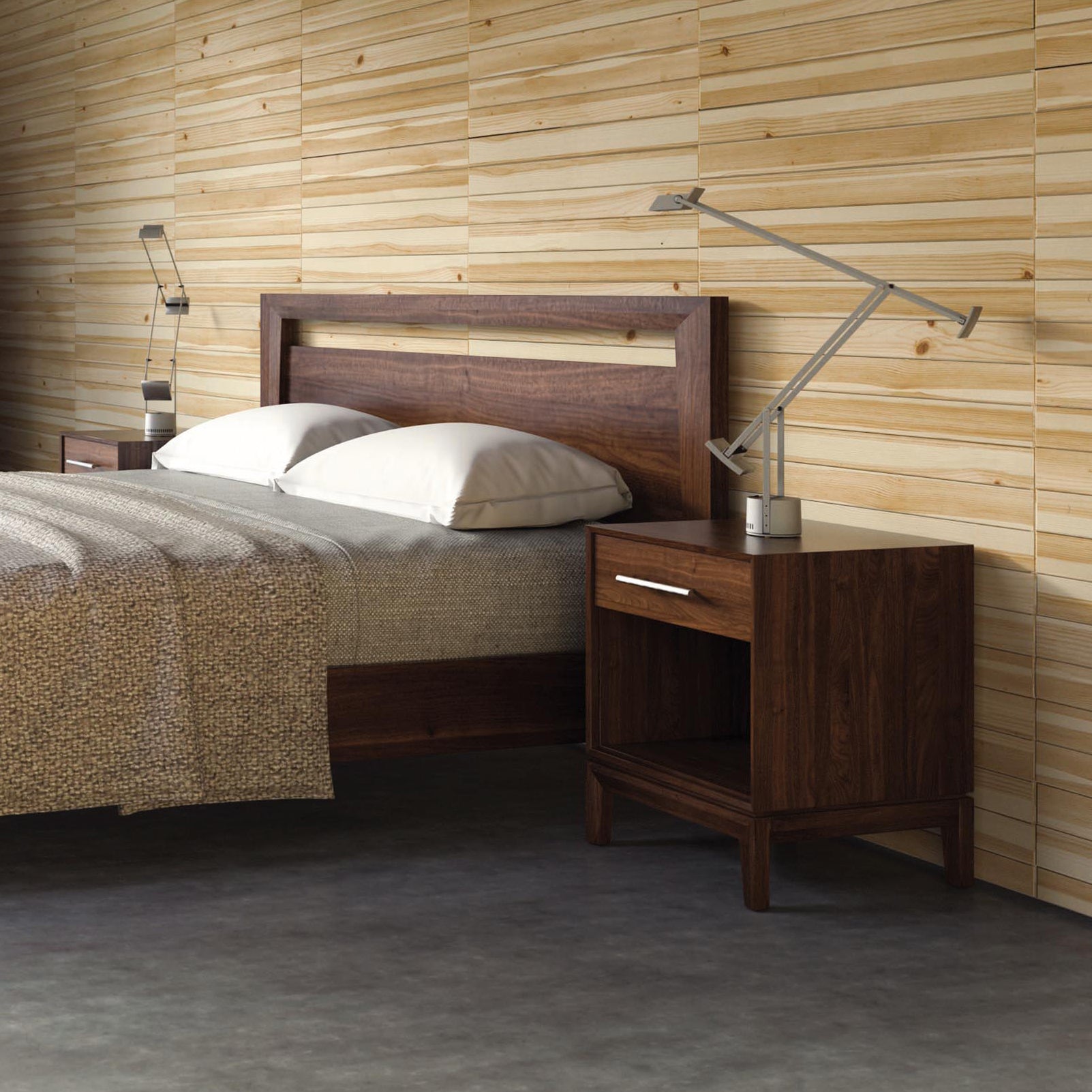 A bedroom with a modern design features a wooden bed frame with a white pillow and a beige blanket. Two Mansfield 1-Drawer Enclosed Shelf Nightstands from Copeland Furniture are placed on each side of the bed, each with a silver desk lamp. The wall is clad in horizontal wooden panels, highlighting the room's organic solid wood elements.