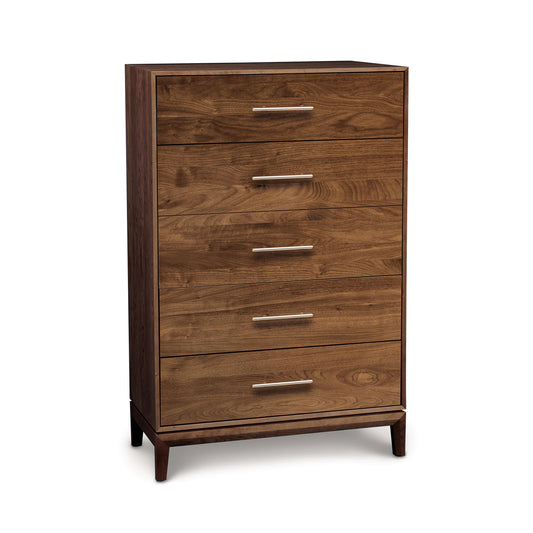 An image of a trendy modern bedroom with an additional storage space, featuring the Copeland Furniture Mansfield 5-Drawer Wide Chest - Walnut - Ready to Ship.