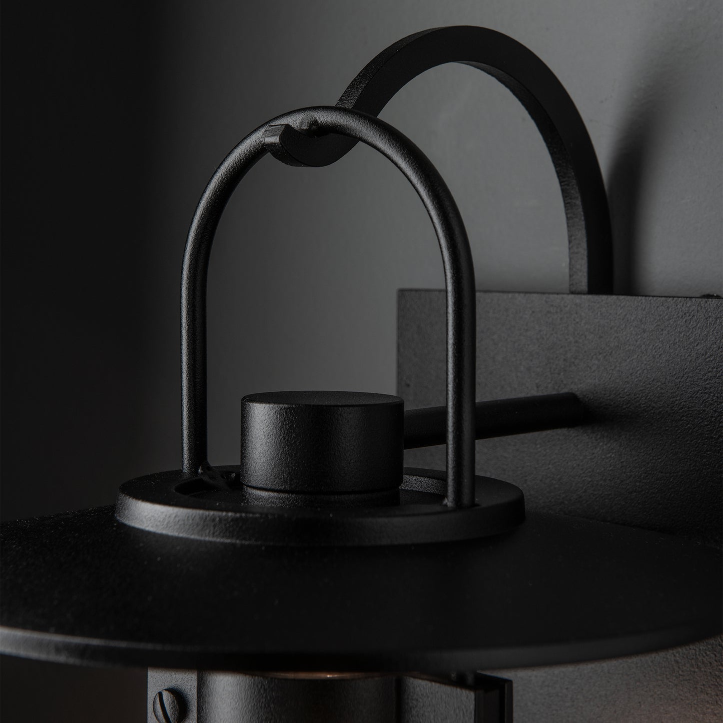 Black Mason Outdoor Sconce by Hubbardton Forge, showcasing elegant curved lines and subtle Steampunk design, American crafted quality.