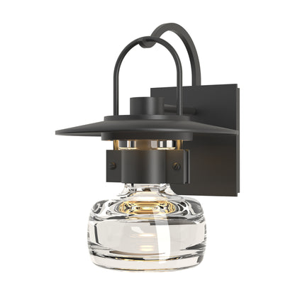 Mason Outdoor Sconce by Hubbardton Forge with black metal frame, curved arm, hand-blown glass shade, and square backplate, American made.