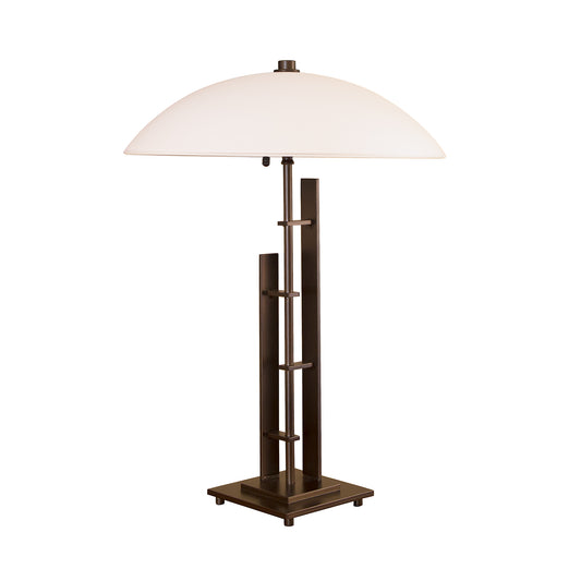 Handmade metal forging techniques are showcased in this Hubbardton Forge Metra Double #1 table lamp, featuring a white shade and a metal base.