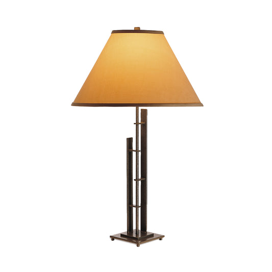 The Hubbardton Forge Metra Double #2 Table Lamp combines an Asian influence with a sleek metal base and a beige shade.