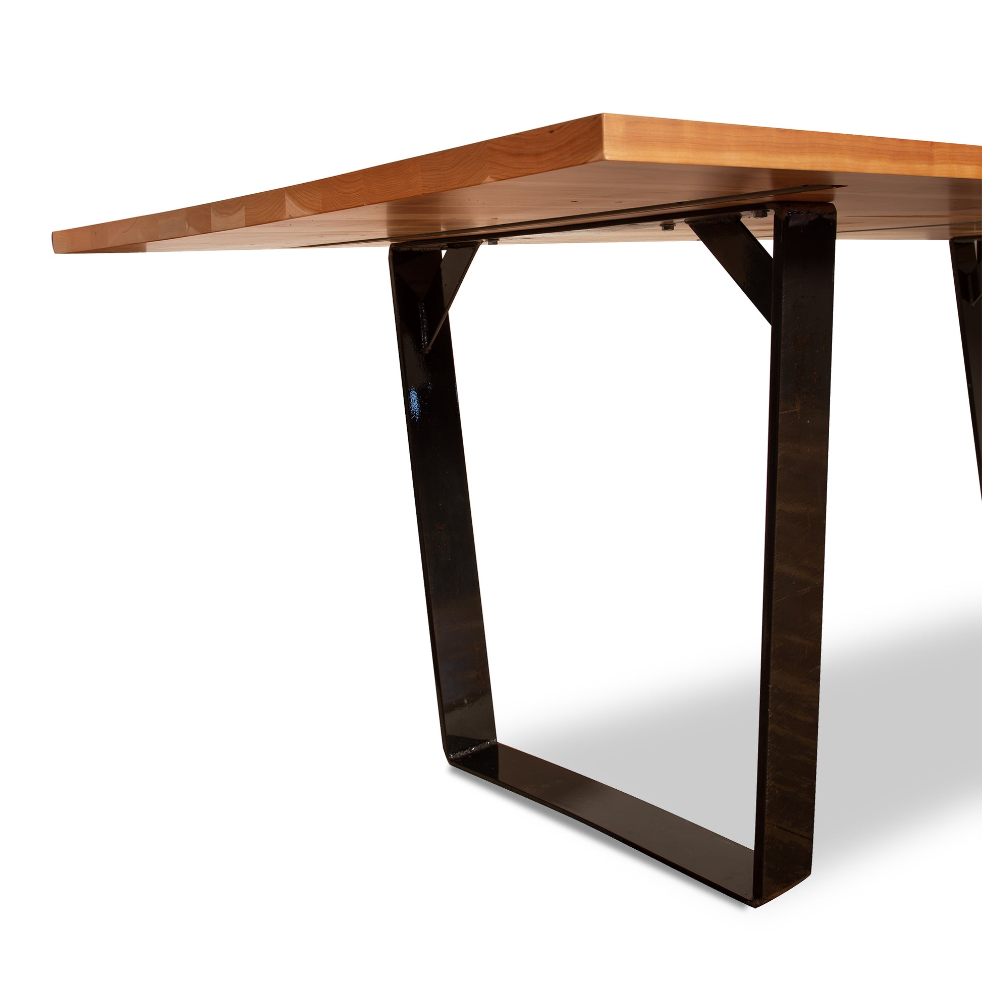 A Metropolitan Solid Top Dining Table with a metal base by Lyndon Furniture.
