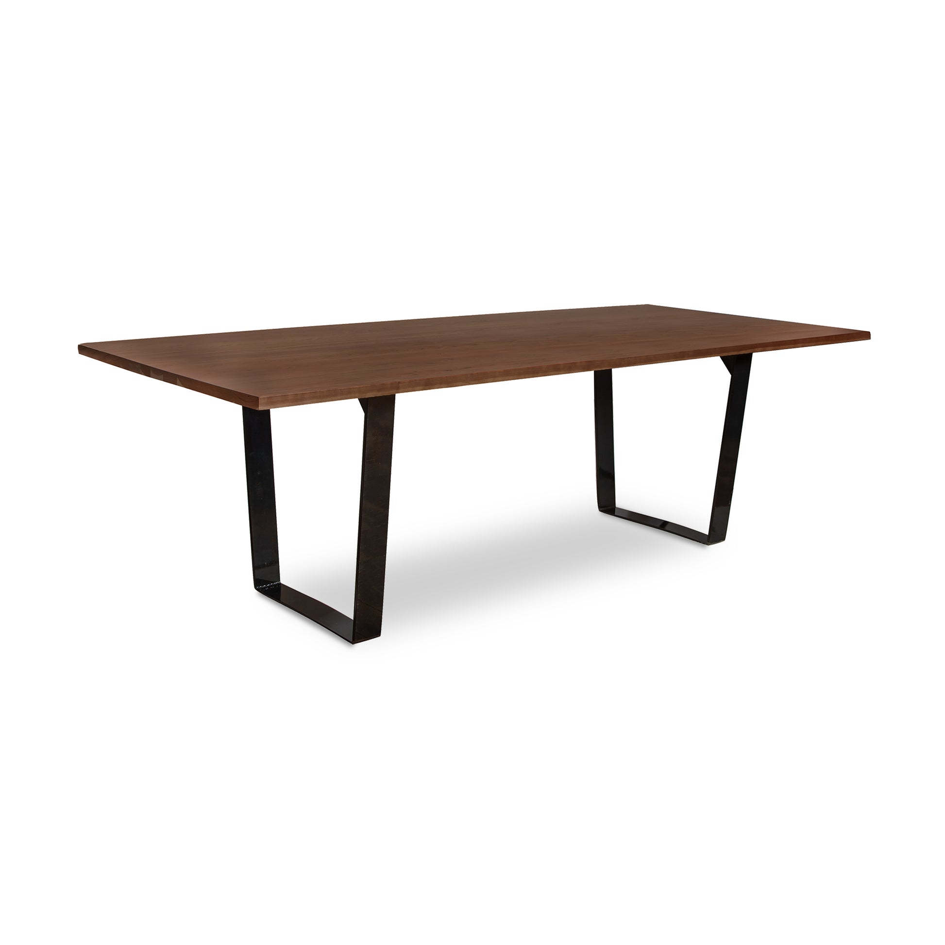 A Metropolitan Solid Top Dining Table from Lyndon Furniture with a wooden top and black legs supported by a metal base.
