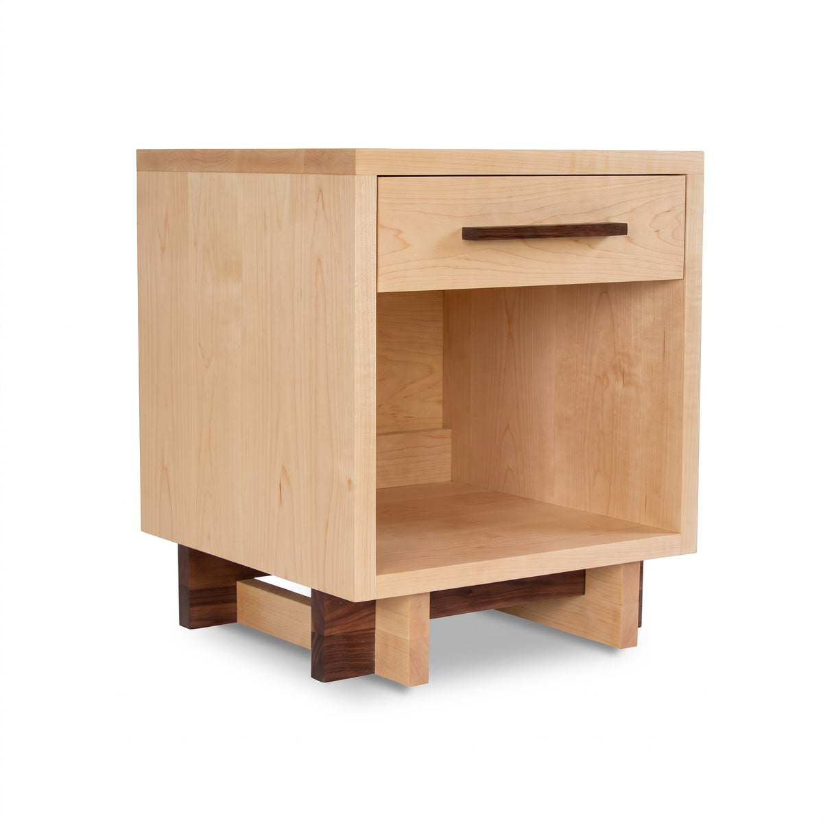 Modern American nightstand by Vermont Furniture Designs featuring a light wood finish, dark base, single drawer, and enclosed shelf.