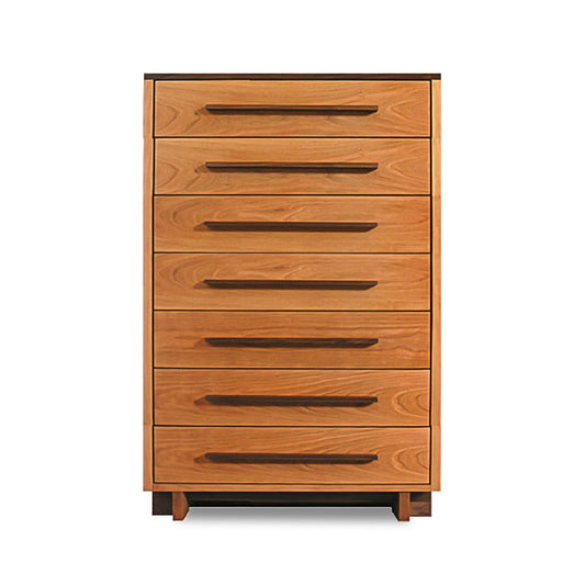 A Vermont Furniture Designs Modern American 7-drawer chest made of natural cherry with six visible handle-less slots for pulling out the drawers, set against a plain background, ideal as sophisticated bedroom furniture.