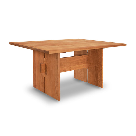 Alt text: Solid wood Modern American Dining Table by Vermont Furniture Designs with a rectangular top and wide legs, handcrafted in Vermont. Natural finish emphasizes wood grain patterns. Ideal for dining room, made in USA.