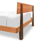 King-size Modern American Platform Bed by Vermont Furniture Designs with a light brown headboard, dark brown legs, and white mattress, shown from rear corner.