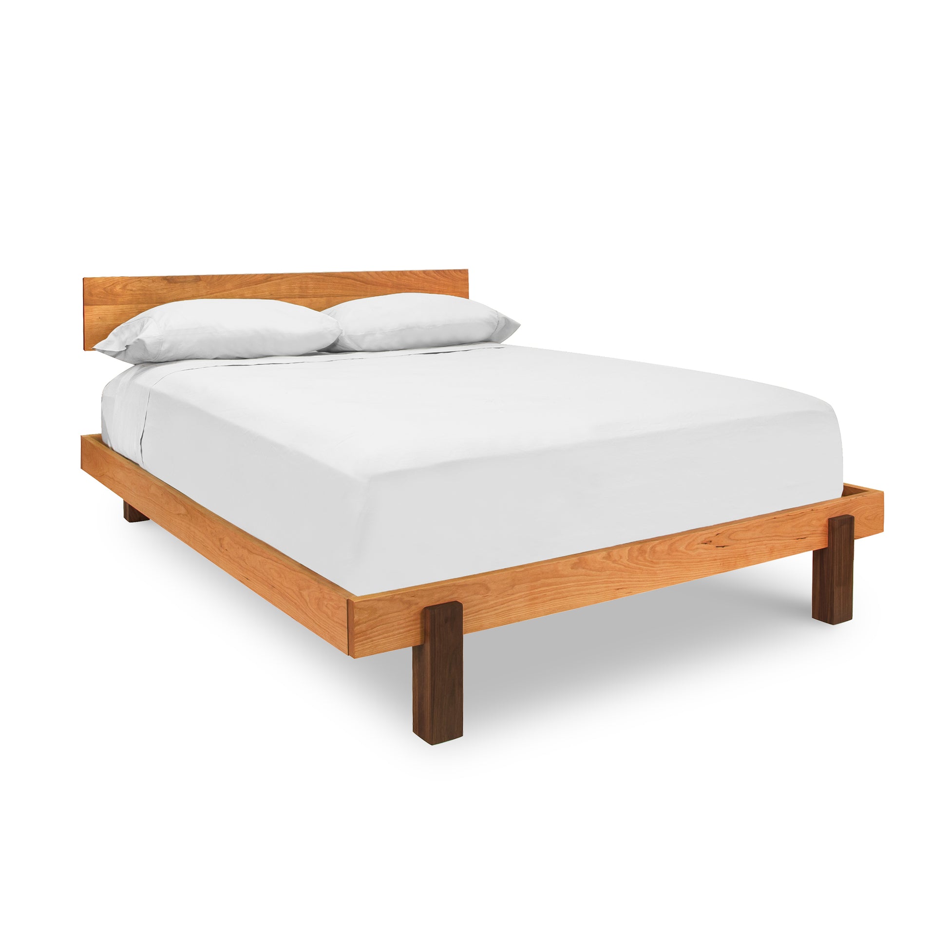 A bed with a wooden frame and white sheets.