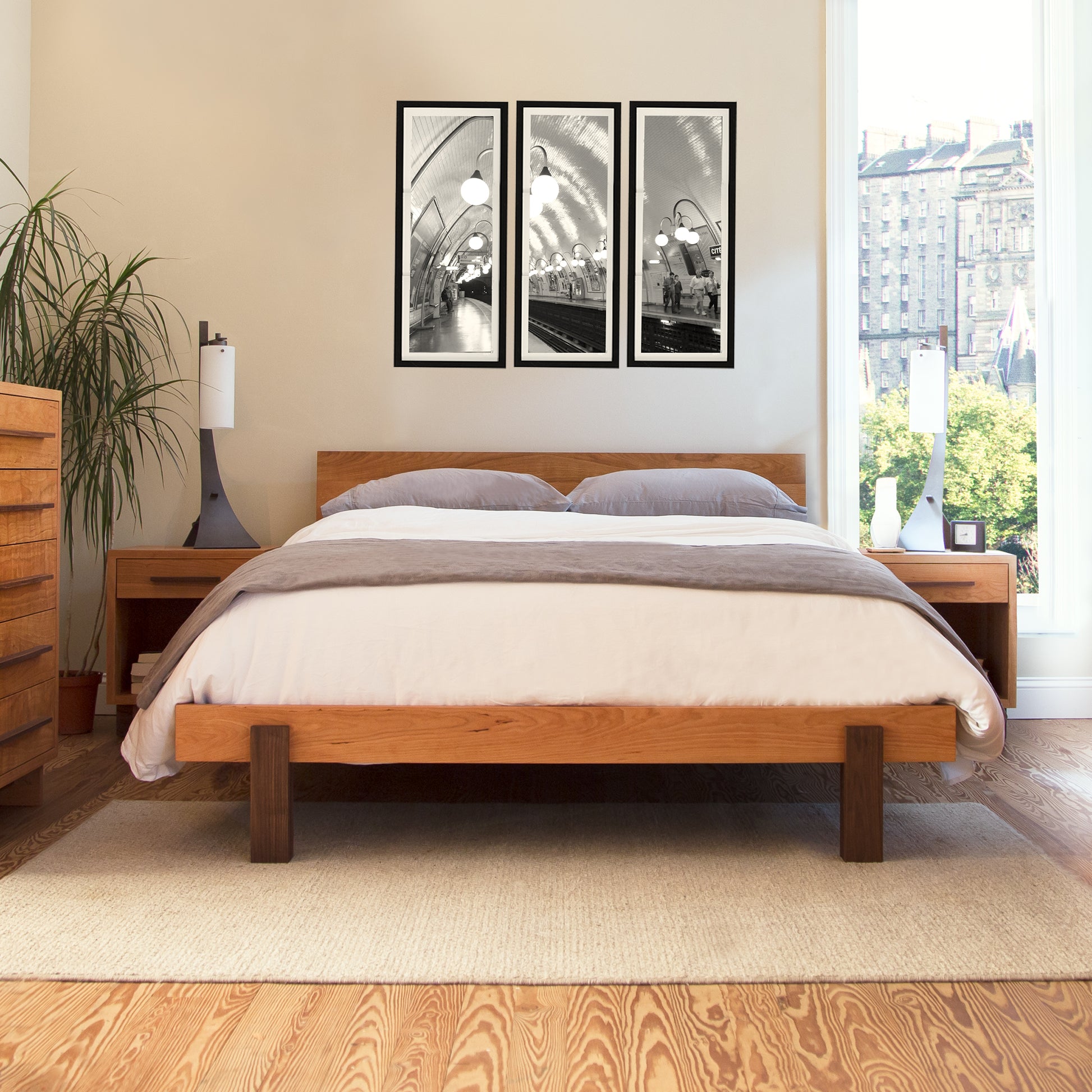 Vermont Furniture Designs Modern American Platform Bed with beige bedding and hardwood bedside tables.