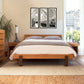 Modern American Platform Bed by Vermont Furniture Designs, flanked by matching bedside tables and a dresser, showcasing high quality craftsmanship and contemporary design.