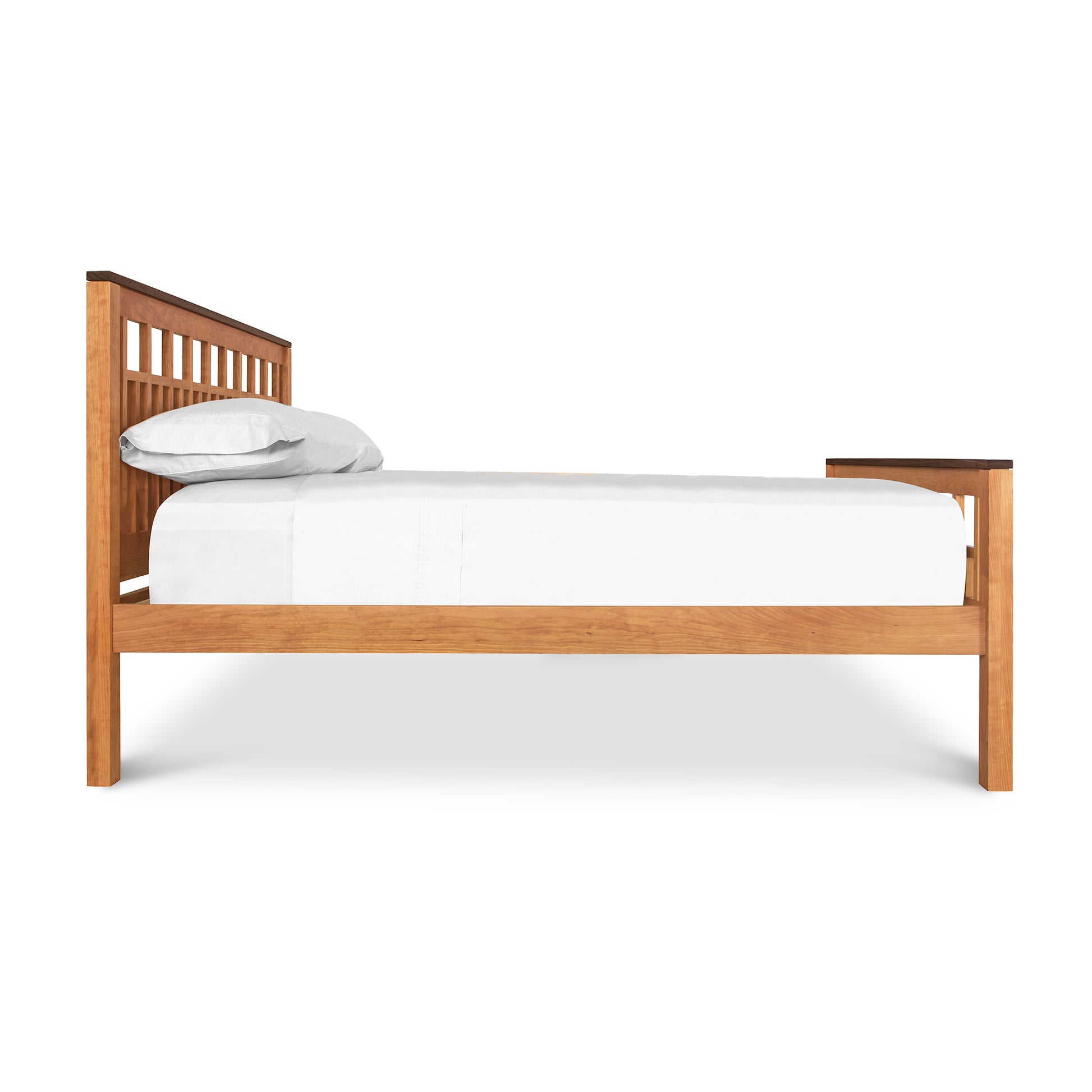 A Vermont Furniture Designs Modern American Trellis Bed, crafted from solid hardwoods with eco-friendly finish, featuring white bedding and a single pillow, isolated on a white background.