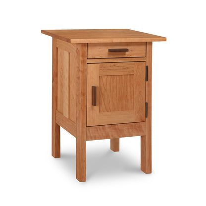 A small wooden nightstand with a drawer, featuring Vermont Furniture Designs' Modern Craftsman 1-Drawer Nightstand with Door.