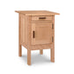 A modern Vermont Furniture Designs nightstand made of solid hardwood construction and natural cherry, isolated on a white background.