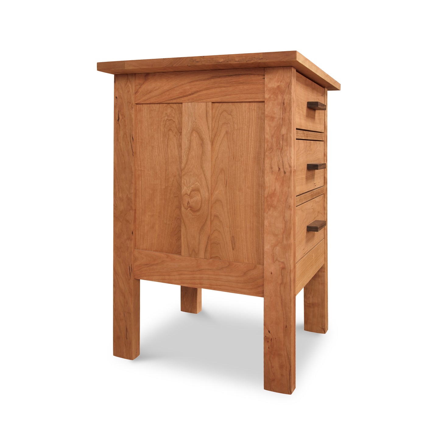 Wooden desk with a single cabinet door and a series of pull-out drawers on the right, isolated on a white background, echoing the Vermont Furniture Designs Modern Craftsman 3-Drawer Nightstand style.