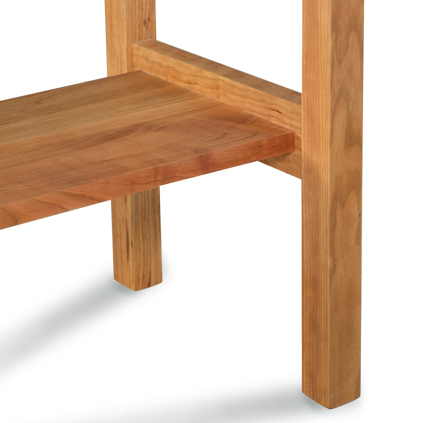 A close-up view of a handcrafted Vermont Furniture Designs Modern Craftsman 2-Drawer Console Table, showing the detail of the corner joinery and the wood grain.