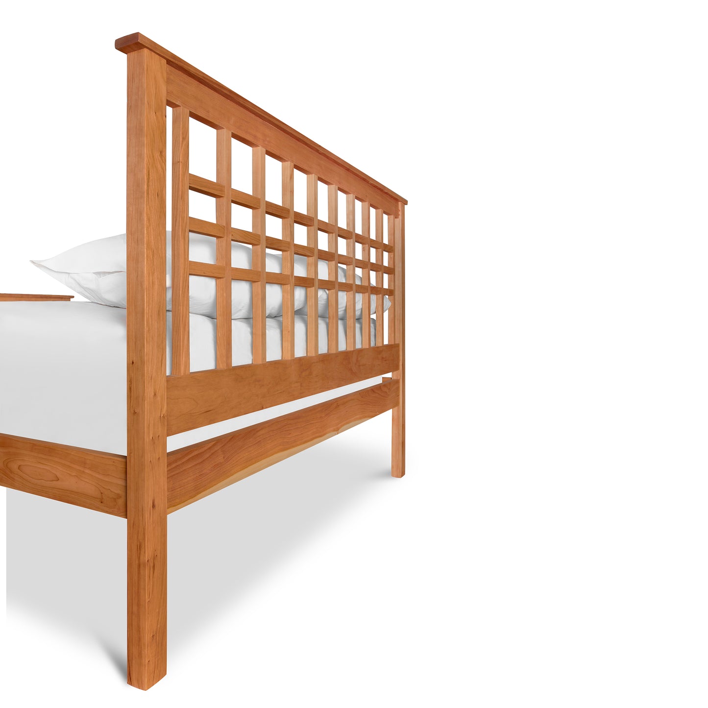 Solid cherry wood Modern Craftsman High Footboard Bed frame with a grid pattern headboard and white bedding on an isolated white background, finished with an eco-friendly oil by Vermont Furniture Designs.