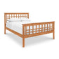 A Modern Craftsman High Footboard Bed from Vermont Furniture Designs with a white sheet on it.