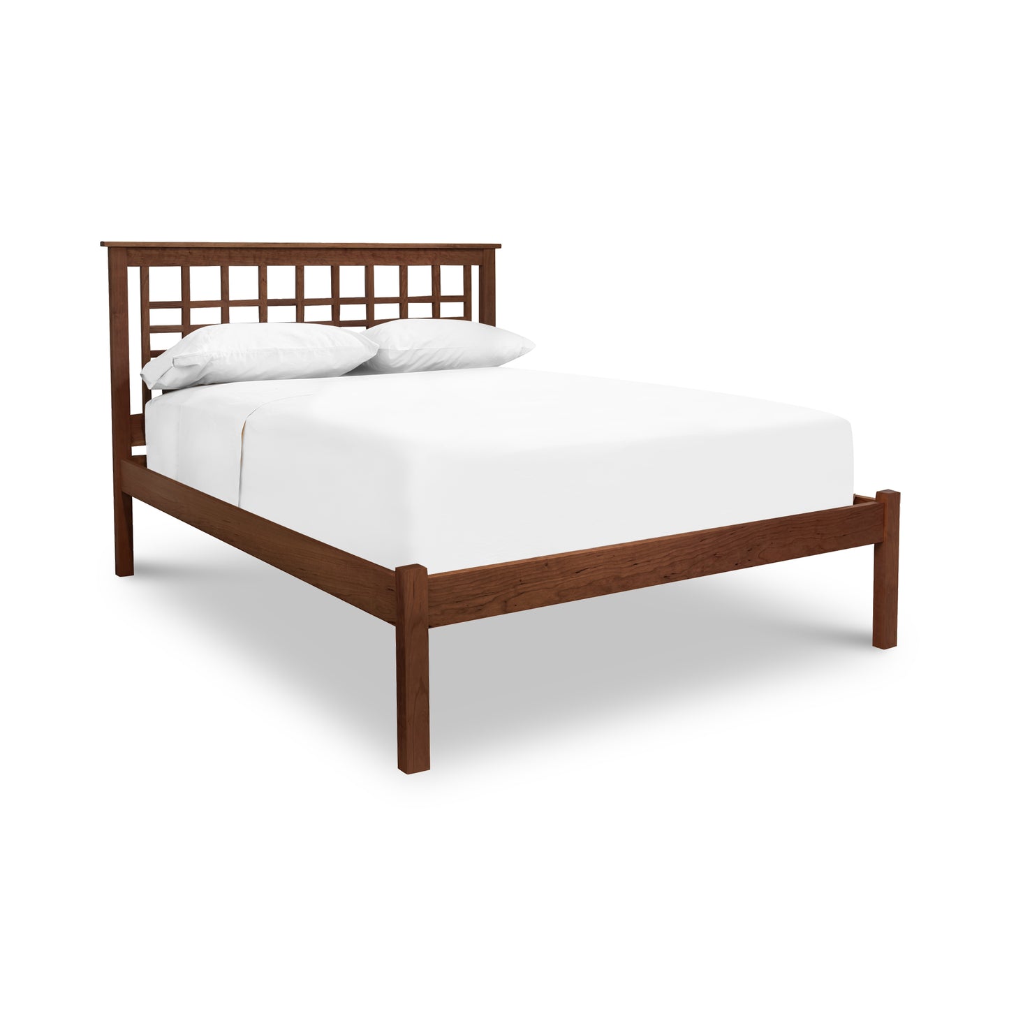 Solid wood Arts and Crafts style bed frame with lattice headboard, Modern Craftsman Low Footboard Bed by Vermont Furniture Designs, featuring white bedding and two pillows.