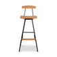 Modern Industrial Stool with Back by Vermont Woods Studios showcasing a curved wood seat and back, supported by a sturdy black metal frame and integrated footrest.