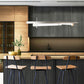 Modern Industrial Stool with Back by Vermont Woods Studios, featuring a sleek wood seat and sturdy frame, positioned at a light wood kitchen island.