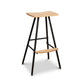Modern Industrial Stool with a curved wooden seat, matching wood footrest, and sleek black metal legs handcrafted by Vermont Woods Studios.