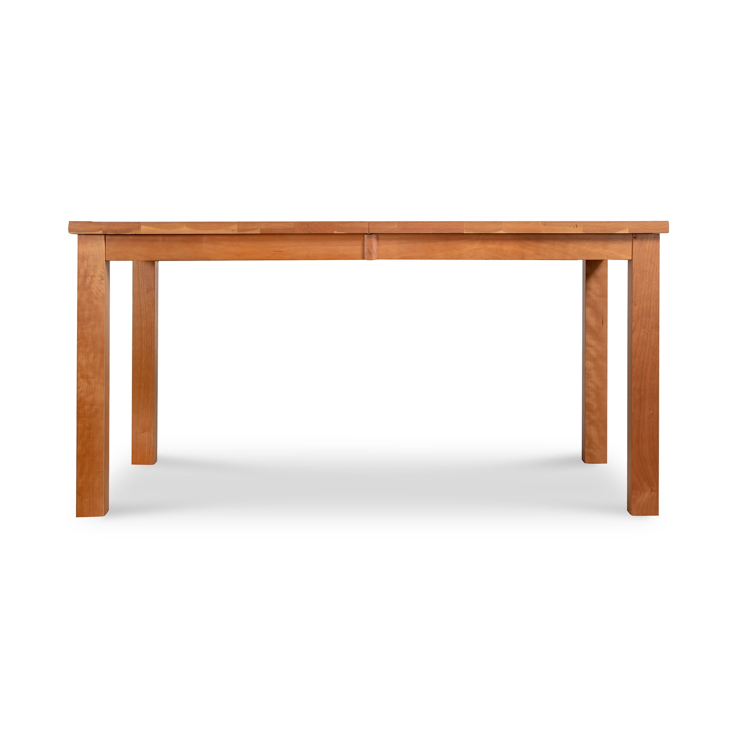 The Modern Mission Parsons Extension Table by Lyndon Furniture, crafted from sustainably harvested solid wood, features a rectangular top and four straight legs. This versatile, medium-toned wooden dining table has a smooth, polished surface and minimalist design. Ideal for both dining and work purposes, this eco-friendly table complements American-made furniture collections including mission and shaker styles.