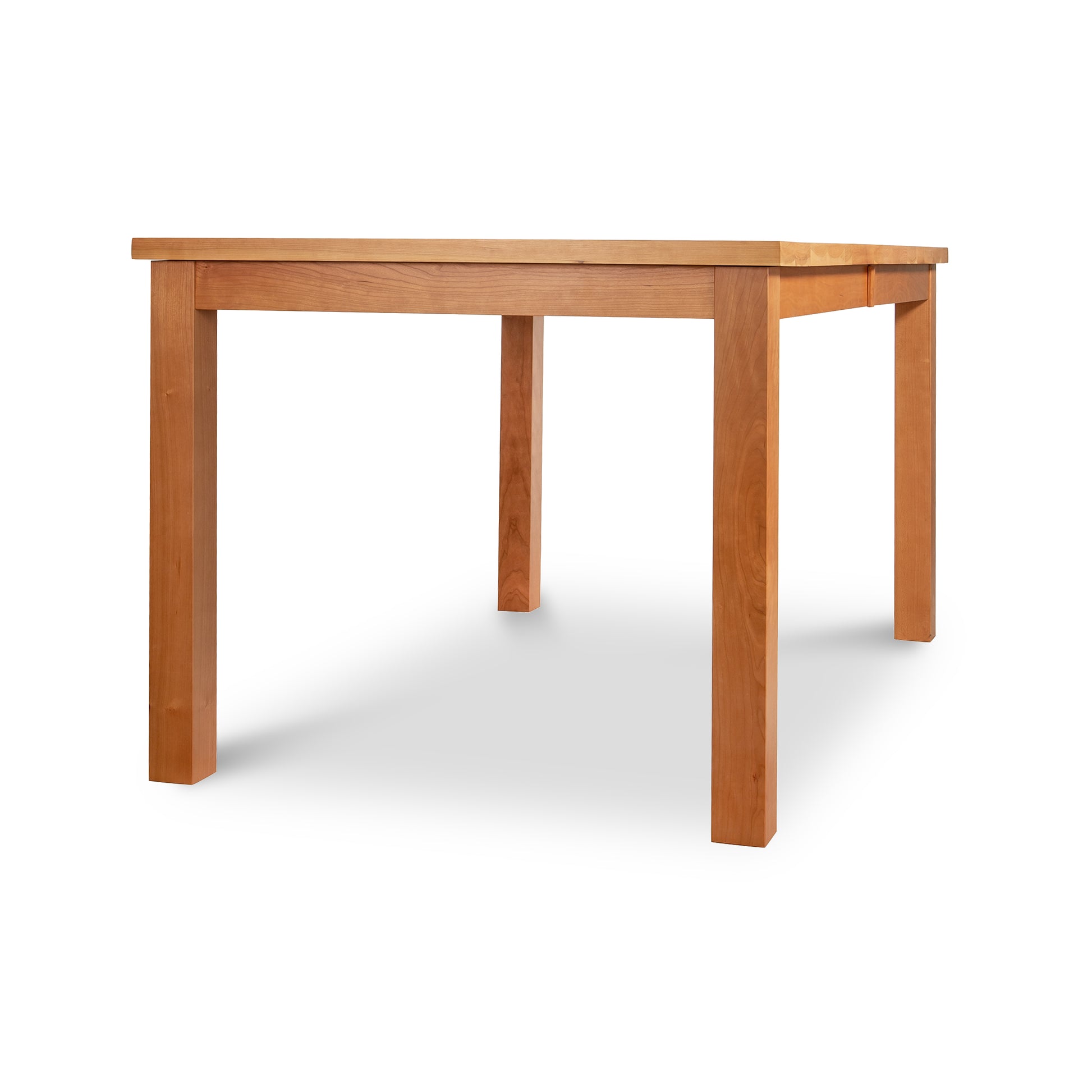 Alt text: Modern Mission Parsons Extension Table by Lyndon Furniture - Handmade Solid Wood Rectangular Dining Table from Vermont, featuring Eco-Friendly Craftsmanship in Light Brown Finish. High-Quality American-Made Wooden Table Set Against White Background.