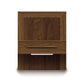 A wooden cabinet door with a single drawer and handle, attached to an eco-friendly Copeland Furniture Moduluxe Attached Nightstand with Drawer - 29" Series, set against a plain background.