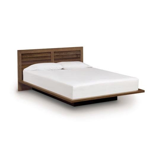 A modern, eco-friendly Copeland Furniture Moduluxe Platform Bed with Clapboard Headboard - 35" Series with a white mattress against a white background.