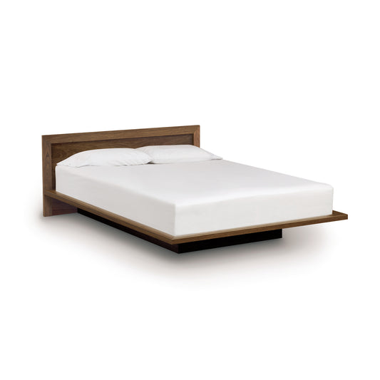 A minimalist Copeland Furniture Moduluxe Platform Bed with Panel Headboard - 29" Series and a white mattress isolated on a white background.