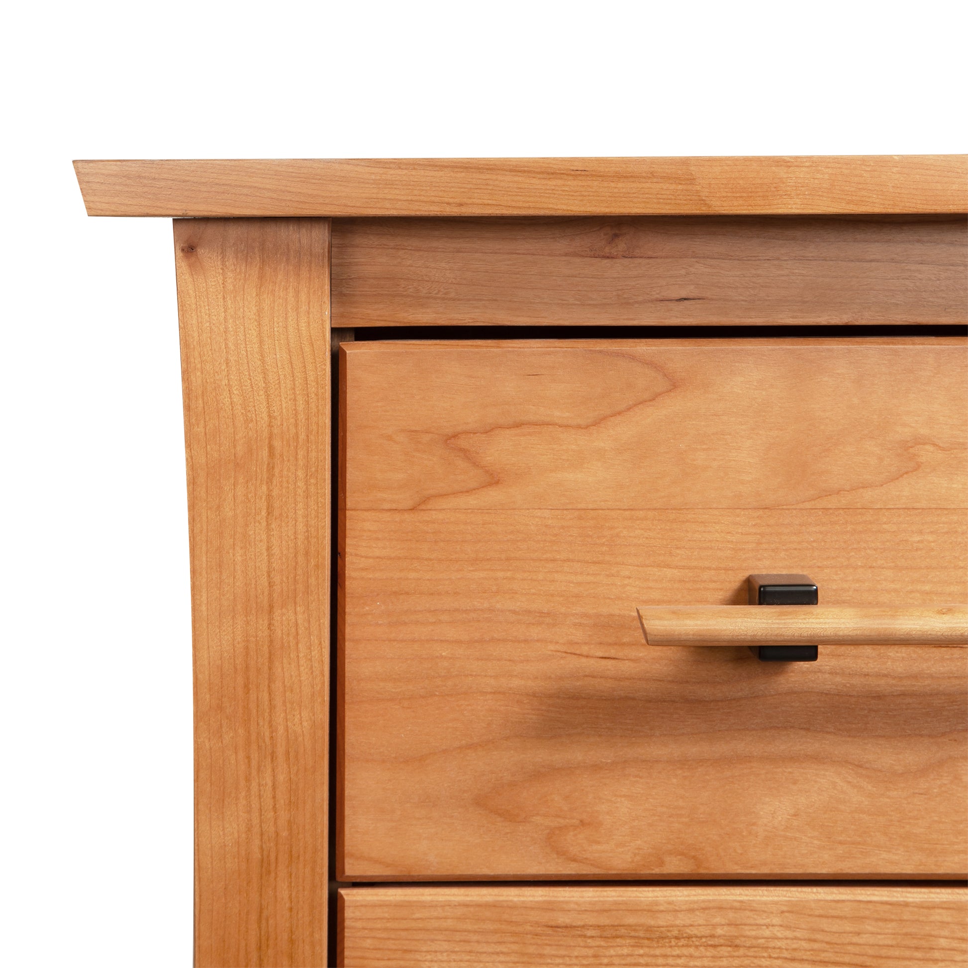 Detail of the Copeland Monterey 2-Drawer Nightstand's top left corner, highlighting its elegant metal and wood handle craftsmanship.