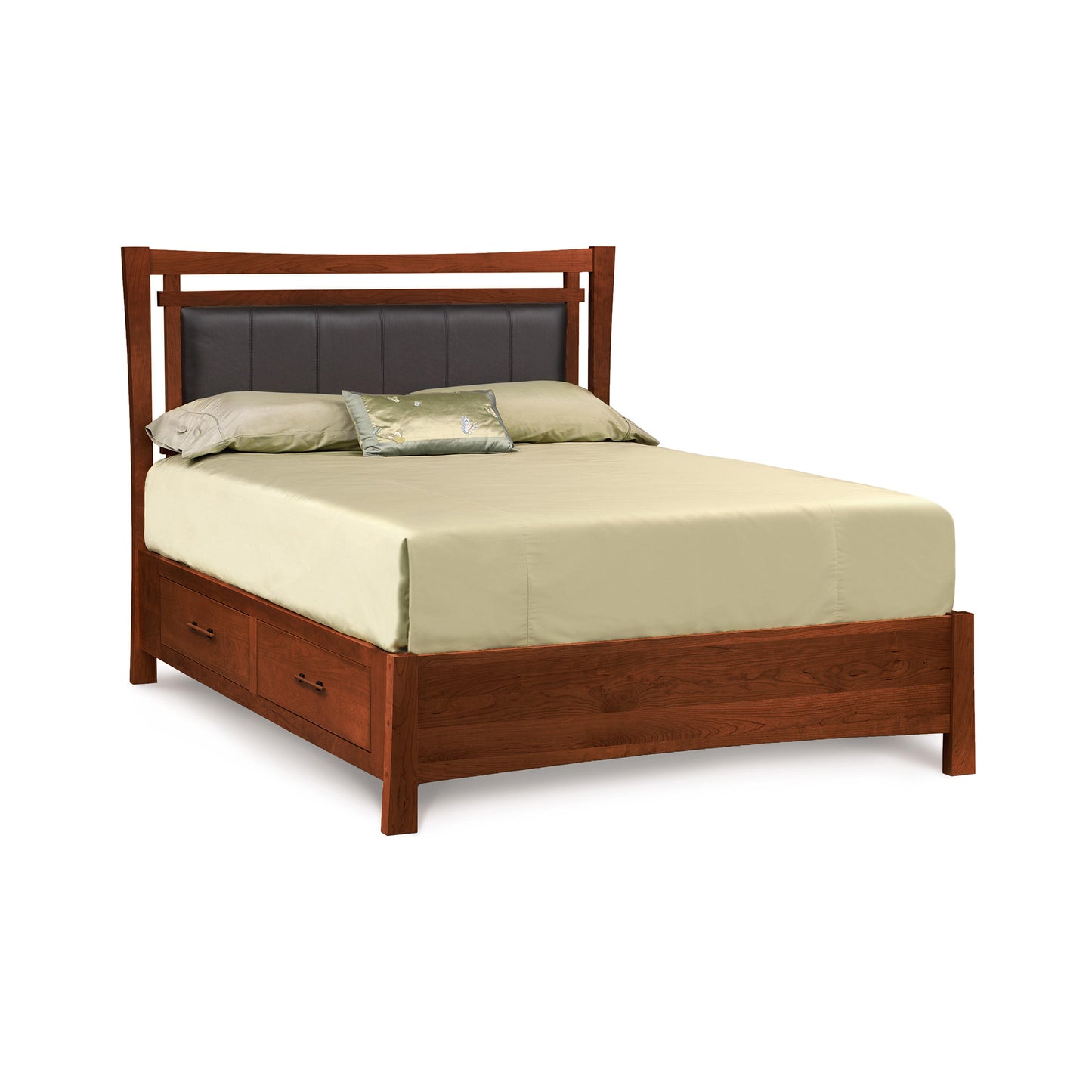 A solid cherry wood queen-size Copeland Furniture Monterey Storage Bed with Upholstered Headboard, dressed with pale yellow bedding and a few decorative pillows, featuring two drawers at the foot of the bed for storage.