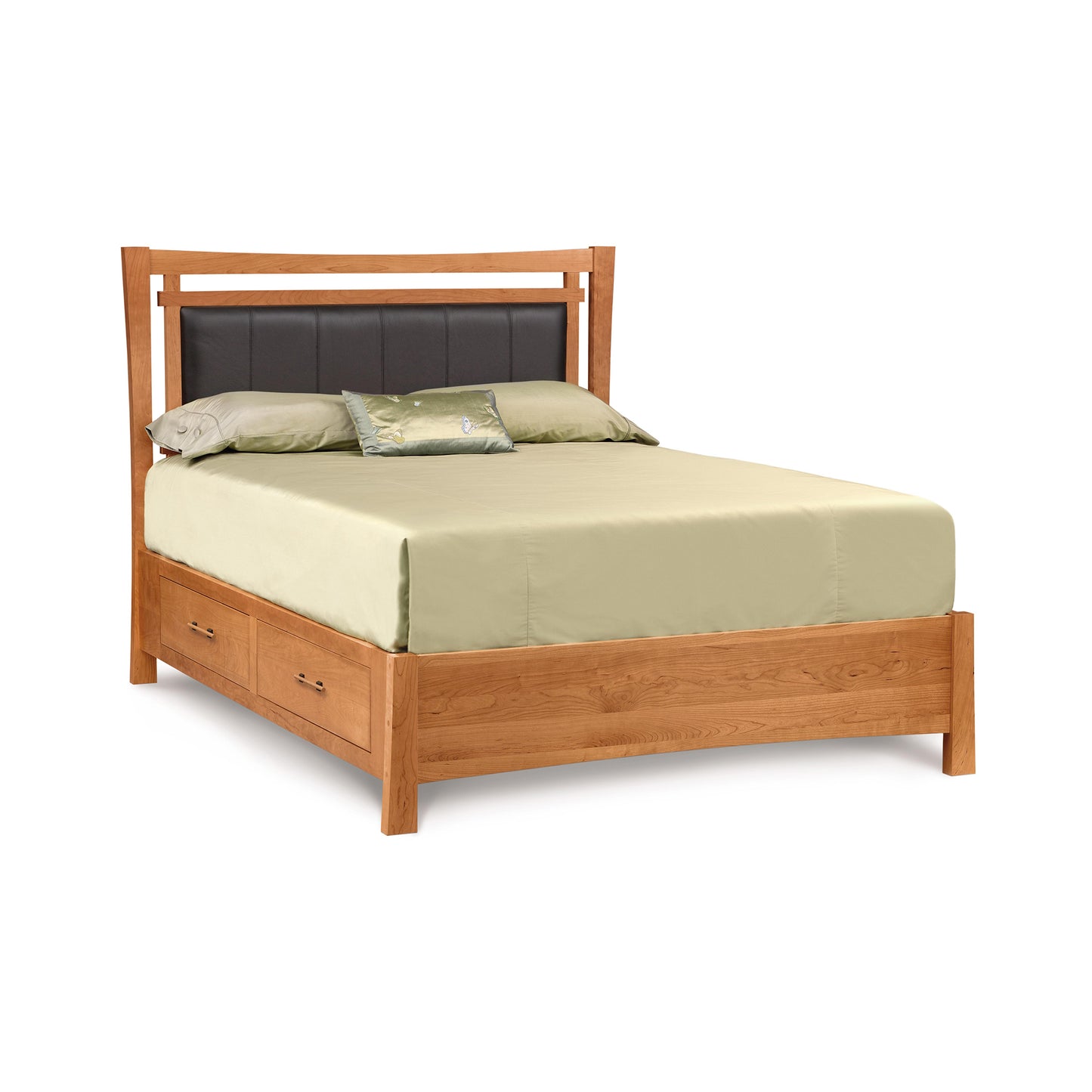 An eco-friendly Monterey Storage Bed with Upholstered Headboard by Copeland Furniture, outfitted with a light green bedsheet, two pillows, and a decorative cushion, set against a white background.