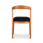 Montgomery Chair by Vermont Woods Studios featuring a cherry wood frame, curved back, and black seat, viewed from behind.