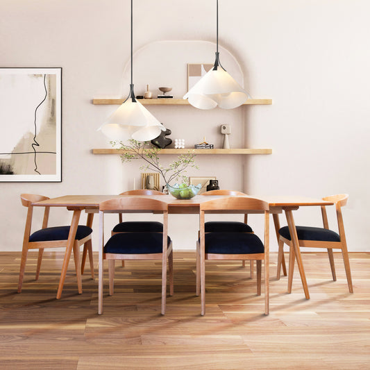 Six Vermont Woods Studios Montgomery Chairs in natural cherry surround a matching wood dining table, showcasing handcrafted American furniture.
