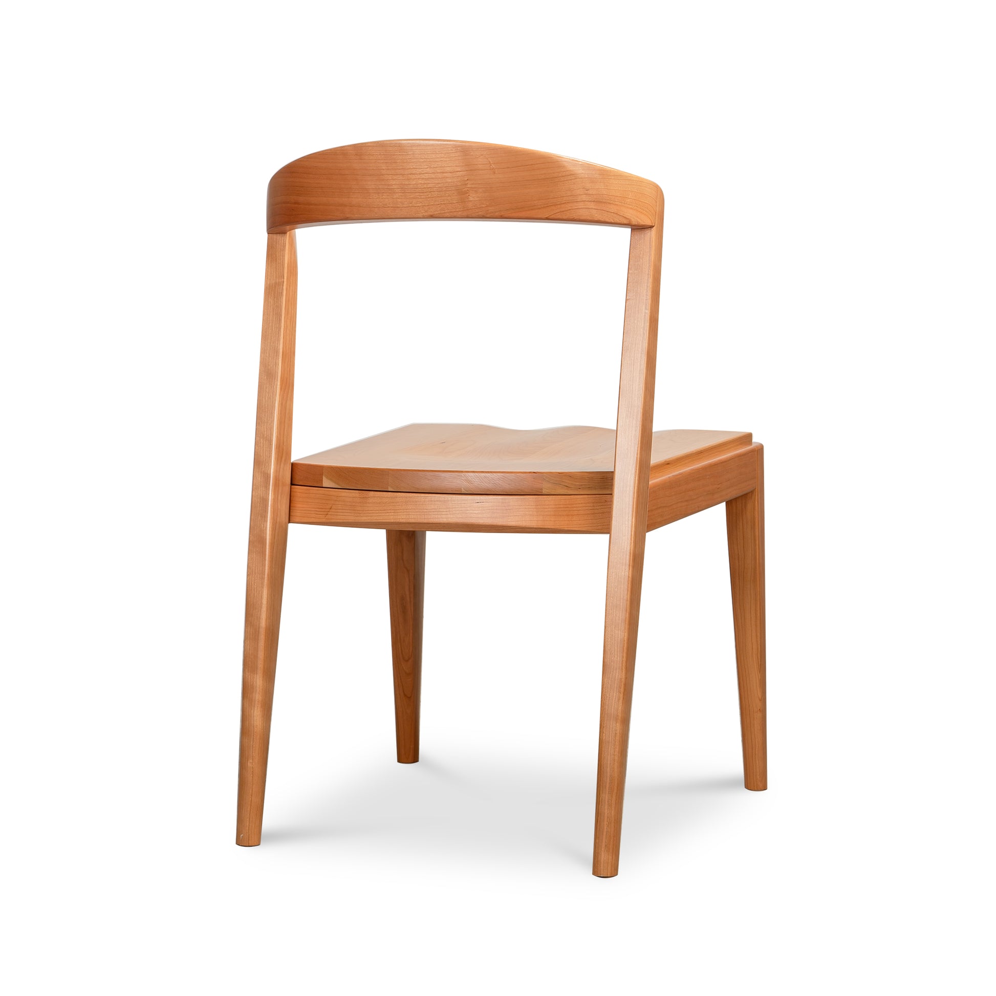 Montgomery Chair with Wood Seat by Vermont Woods Studios shown from behind, featuring its distinctive curved backrest and sturdy four-leg construction.