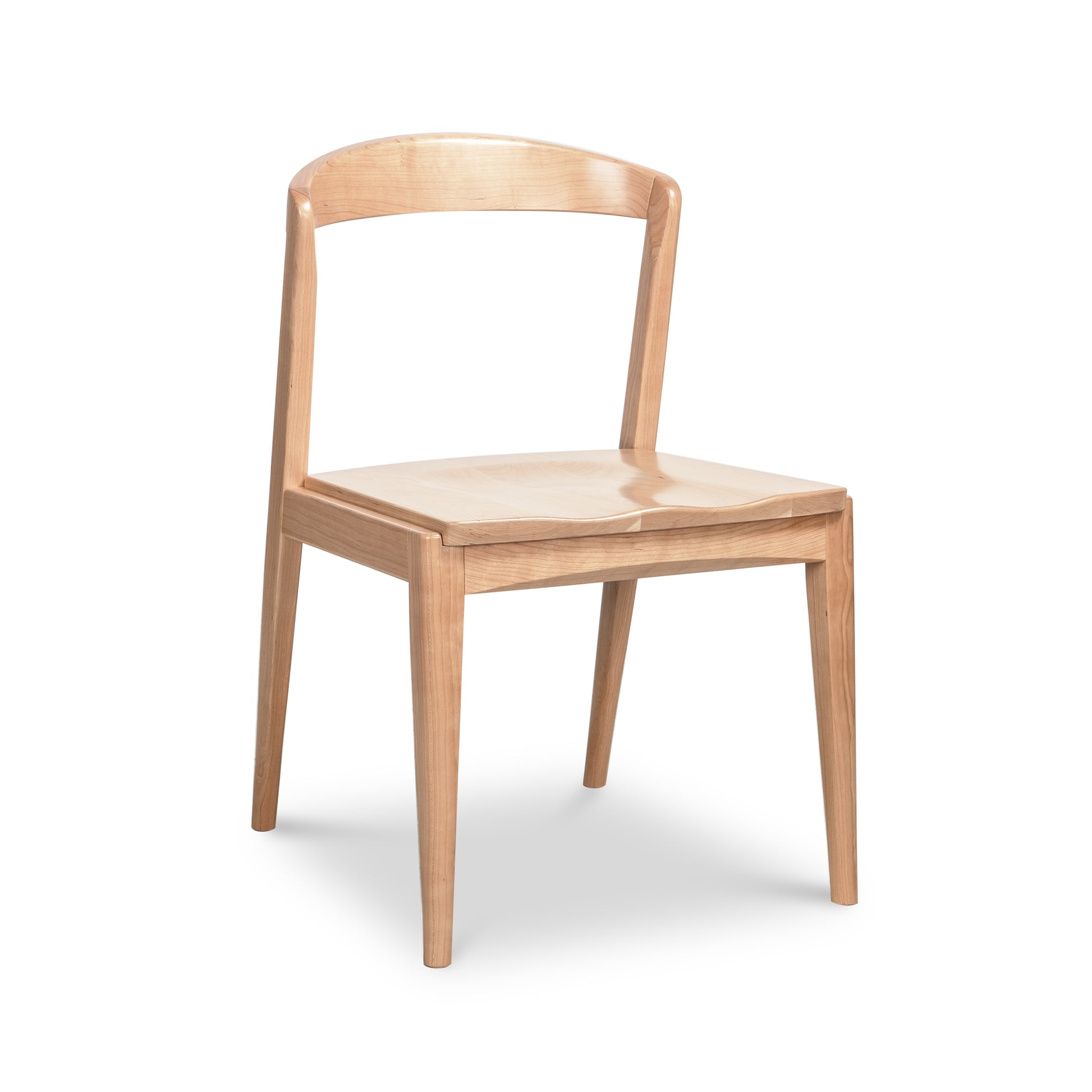 Montgomery Chair by Vermont Woods Studios in light natural cherry, highlighting its curved backrest and four straight legs.