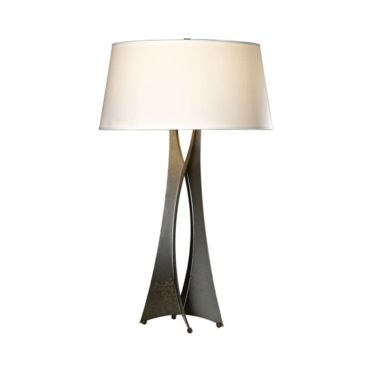A Hubbardton Forge Moreau Table Lamp with a handmade metal base and a white shade.