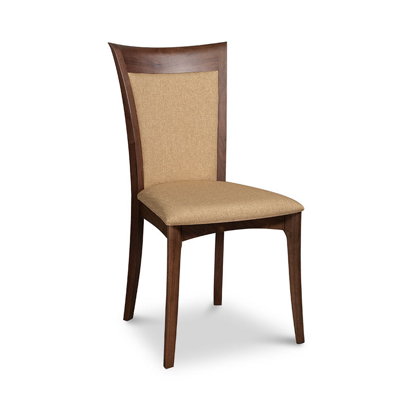 A wooden dining chair with a tan upholstered seat.