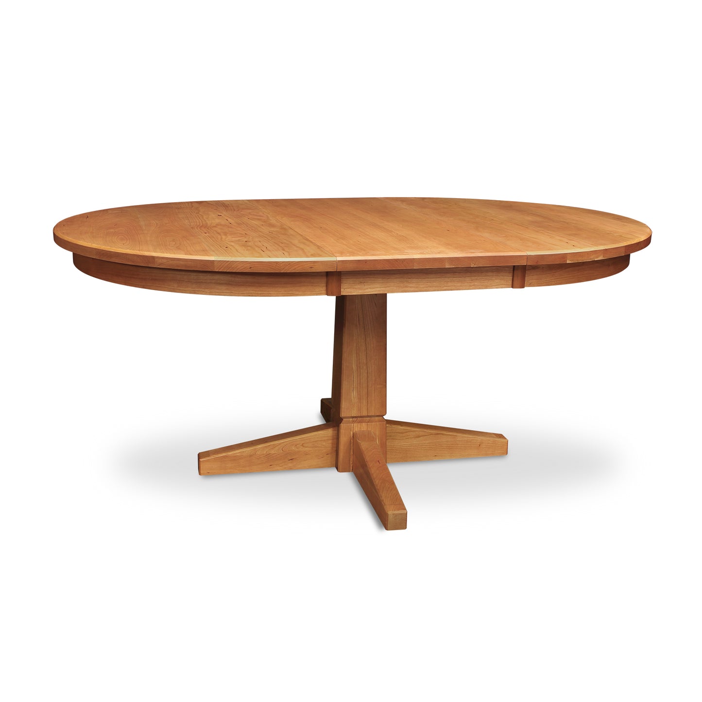 An oval dining table made of Lyndon Furniture's Natural Vermont Single Pedestal Round Extension Table.