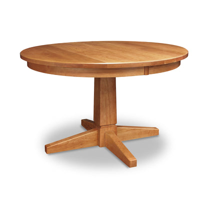 A Lyndon Furniture Natural Vermont Single Pedestal Round Solid Top Table with four legs on a white background.