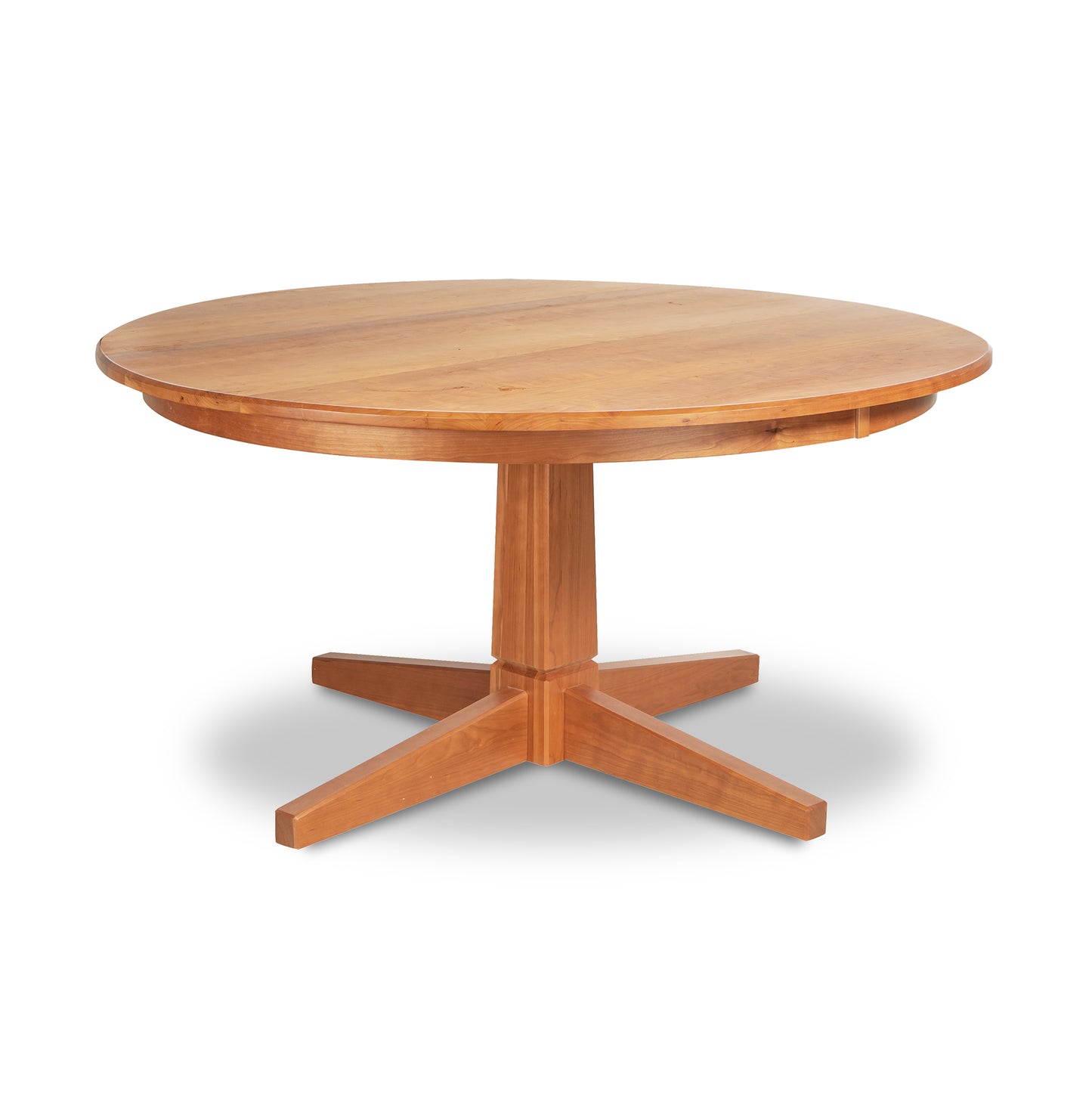 A round wooden table, the Natural Vermont Single Pedestal Round Solid Top Table by Lyndon Furniture, with four legs on a white background.