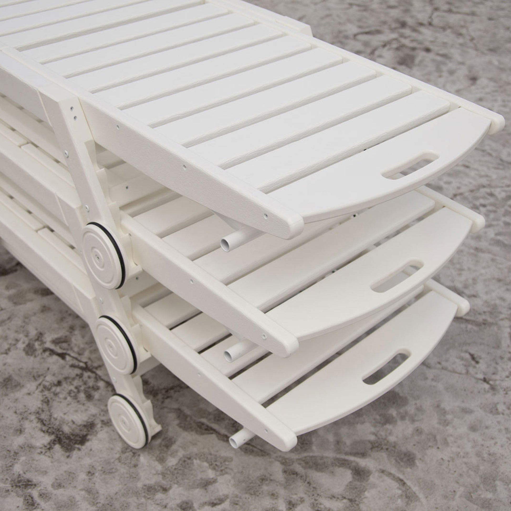 Three POLYWOOD Nautical Wheeled Chaise lounge chairs, stackable and durable, showcase premium American-made outdoor furniture craftsmanship.